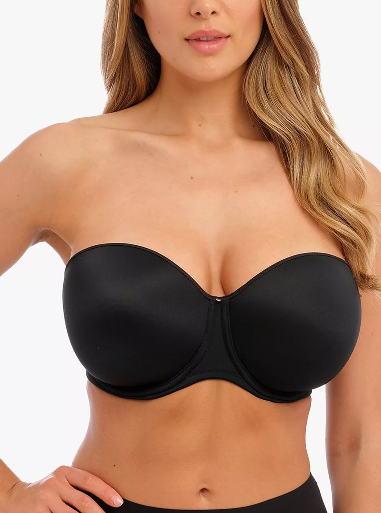 Black strapless bra worn by a model on a white background