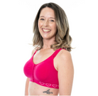 Woman wearing a pink wire free bra with heart designs on a white background