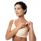 Woman wearing a beige bra on a white background