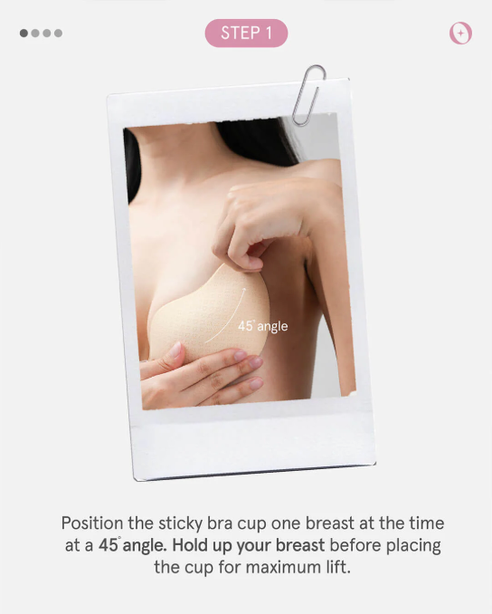 Instructional image showing a person positioning a sticky bra cup with text guidance on angle and lifting technique.