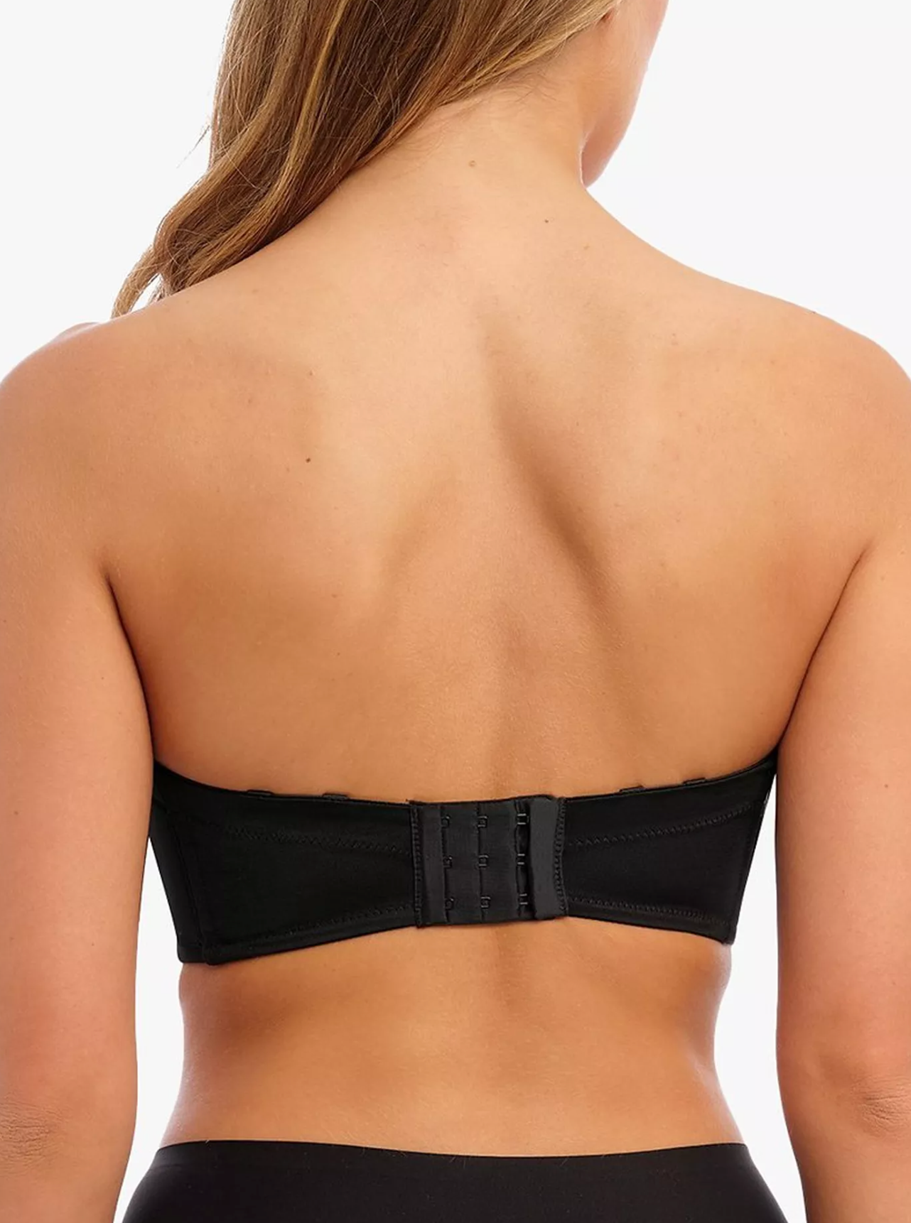 Black strapless top worn by a person on a white background