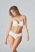 Woman wearing a white lingerie set on a gray background