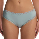 Light blue underwear with lace trim worn by a person on a white background