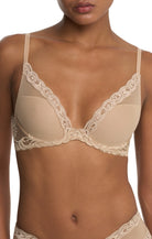 Beige lace bra on a model against a white background