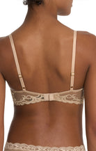 Beige lace bra on a model with a white background