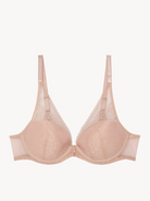 Beige bra with lace details on a white background