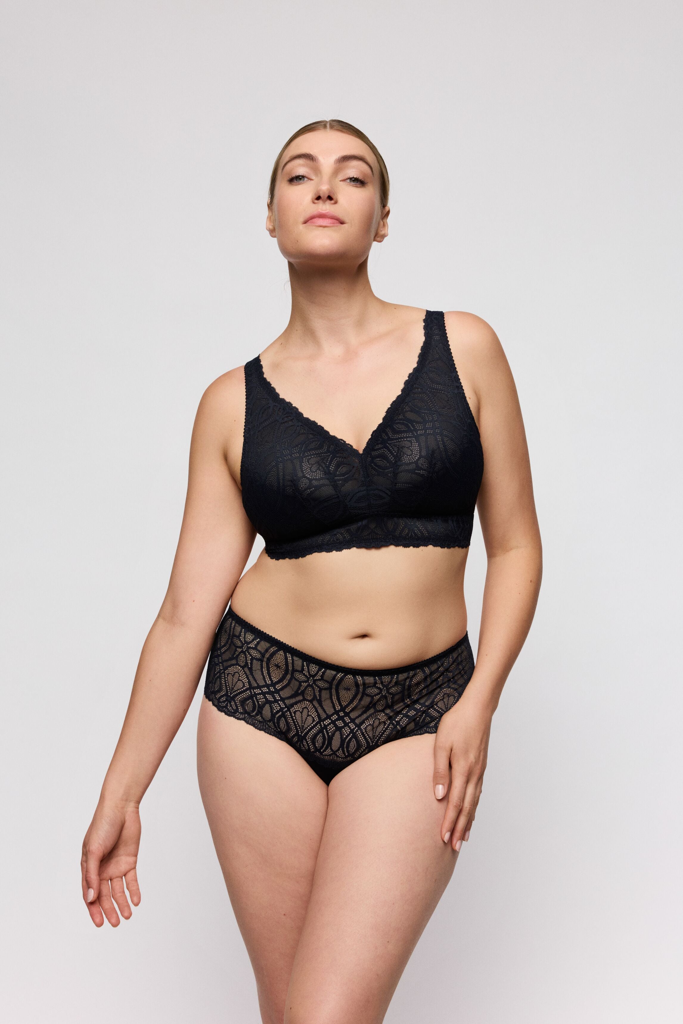 Woman wearing a Prima Donna Salerno Wire-Free Longline Bralette lingerie set on a plain background