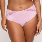 Pink underwear with lace trim on a plain background