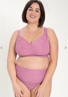 Woman wearing a purple lingerie set on a white background