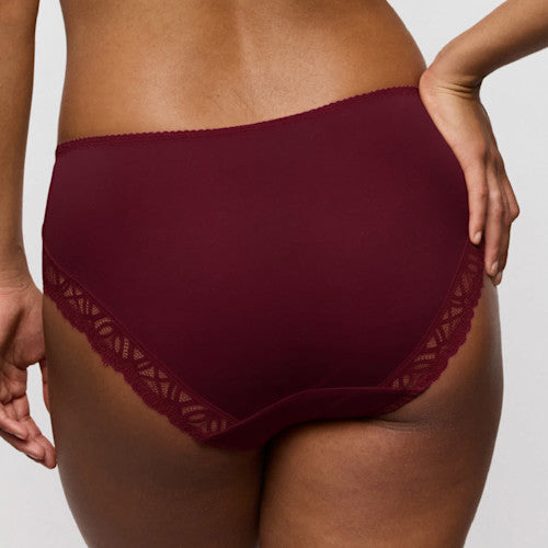Maroon underwear with lace trim on a neutral background