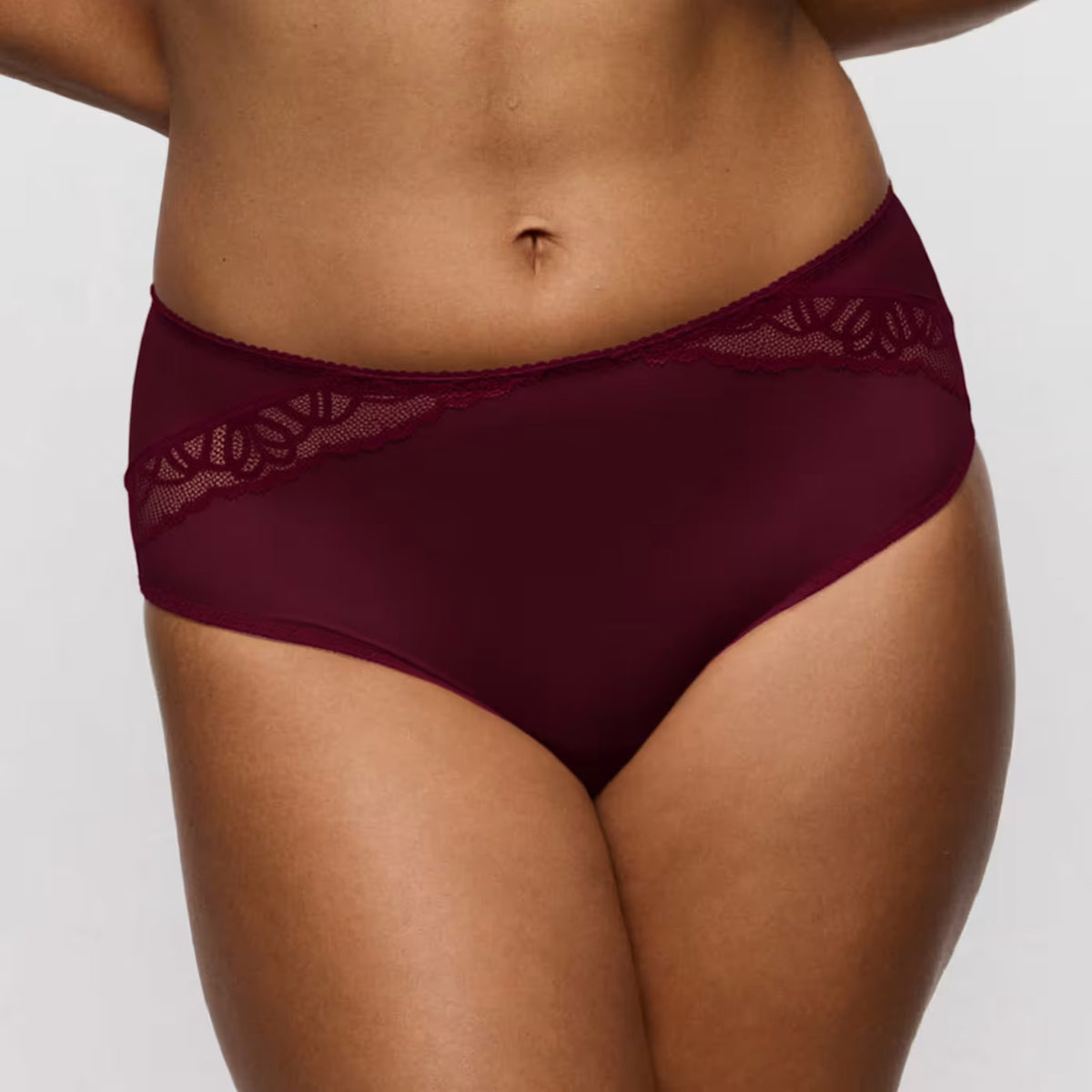 Maroon lace-trimmed underwear on a neutral background