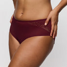 Maroon underwear worn by a person on a plain background