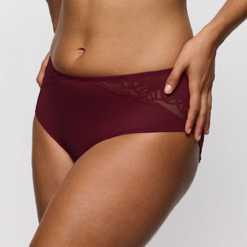 Maroon underwear worn by a person on a plain background